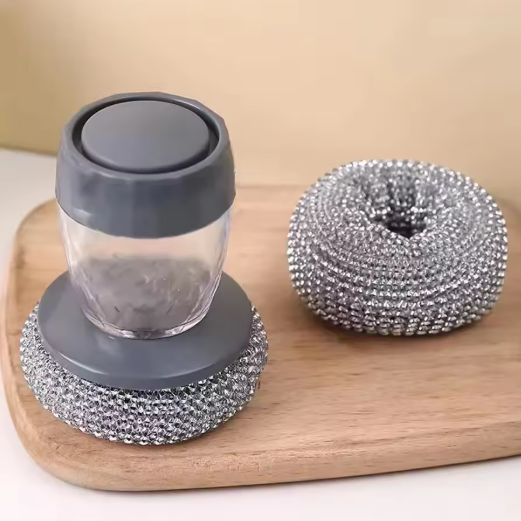 Soap dispenser steel brush with gray lid and gray base on a wooden board